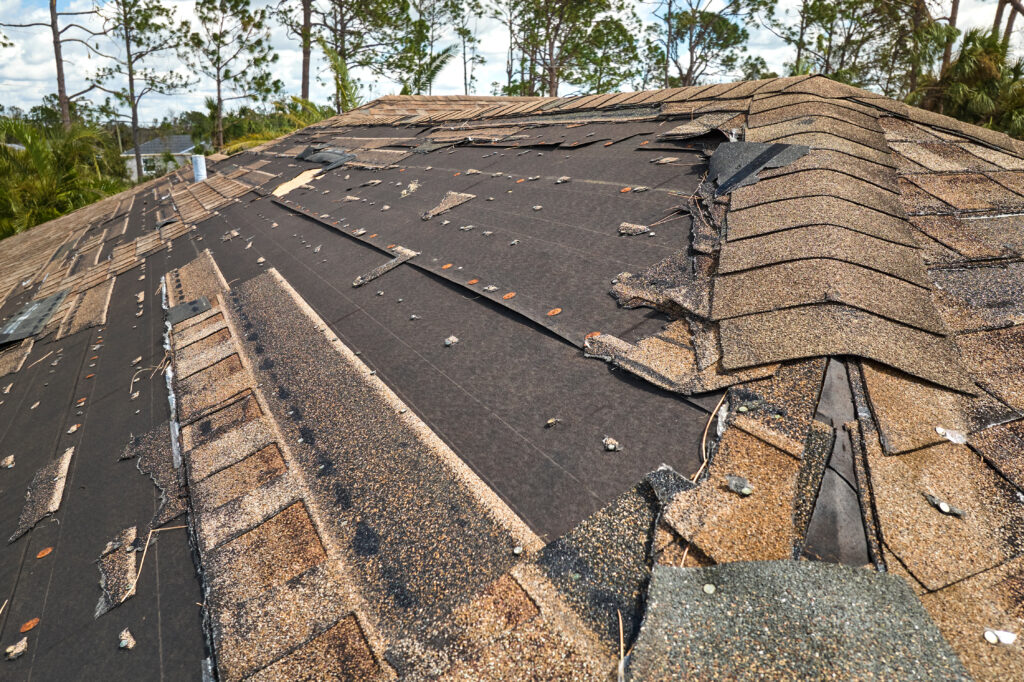 Missing shingles on damaged roof needing repair